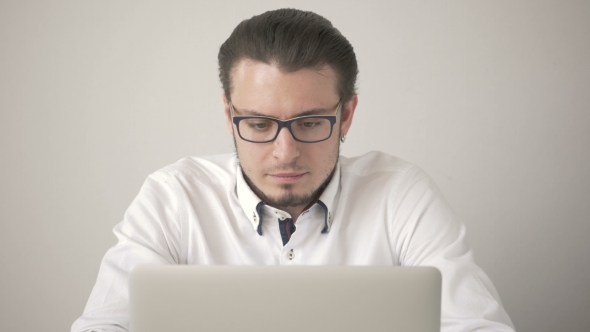 Handsome Young Man In Shirt Working On Laptop While Sitting At His Working Place