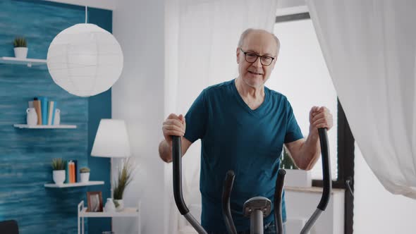 Elder Adult Doing Physical Cardio Exercise on Fitness Bicycle