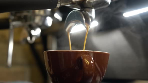 Closeup of Espresso or Americano Pouring in Cup