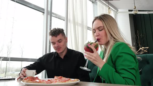 Couple in Love Eating Pizza in a Cafe