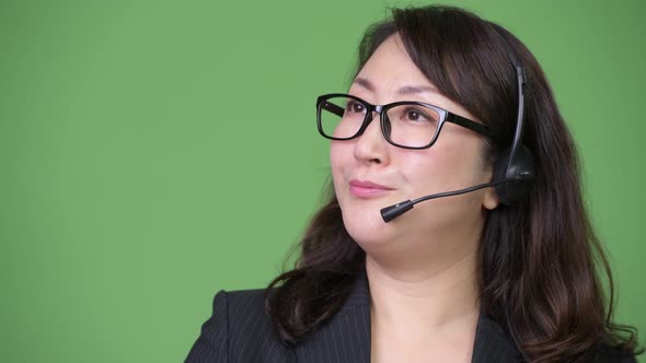 Mature Beautiful Asian Businesswoman Working As Call Center Representative