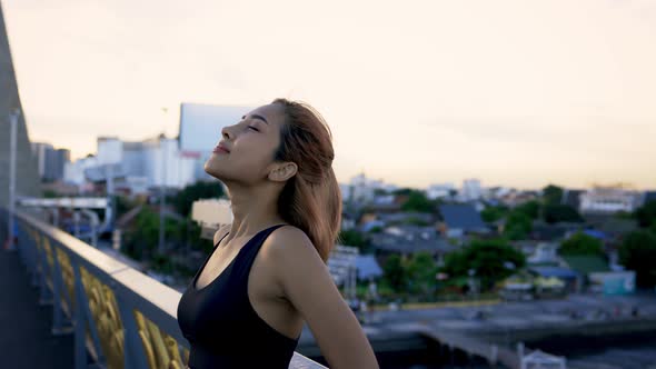 Woman Athlete Relaxing at Sunset