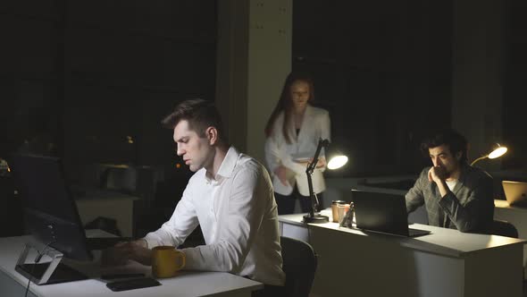 A Redhaired Young Woman Works Late at the Office