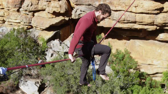 Highline athlete balancing on slackline rope