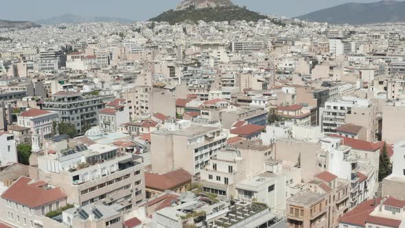 Slow Establishing Dolly Aerial Towards Mount Lycabettus Panning Down Into Athens City, Greece