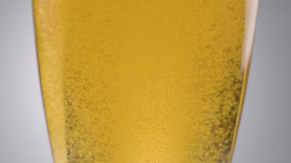 Close up shot, Beer bubbles in slow motion, Fresh golden liquid drink