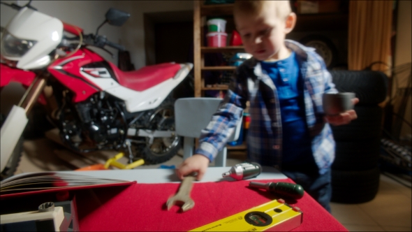 Little Boy Playing In Garage