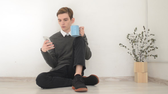 Designer Drinking Coffee, Using Smartphone