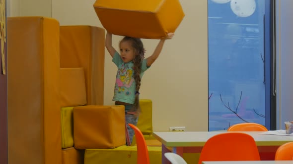 Kid is Building a Wall of a Yellow Mats Takes