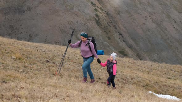 Little Girl with Mother on Mountain Trek