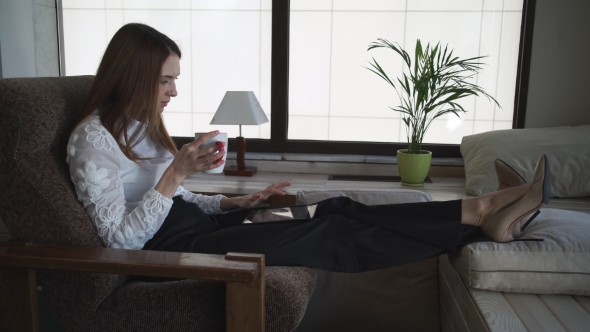 The Woman Sitting And Drinking Coffee