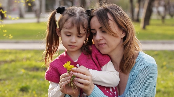 Mother And Daughter Find Flowers In The Bouquet