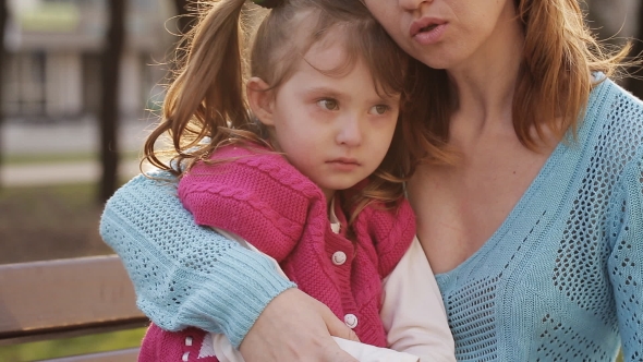 Little Girl Crying Sitting On Mother's Her Lap