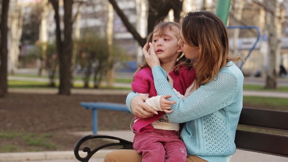 Little Girl Crying Sitting On Mother's Her Lap