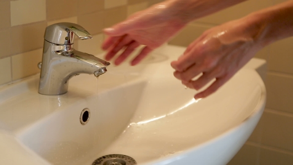 Girl Washes Her Hands Under The Tap