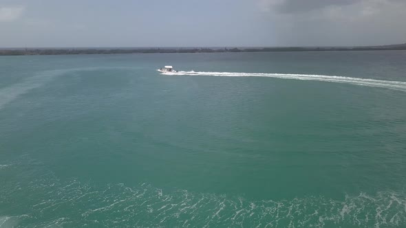 Boat / Vessel / ship cruising across the waters. going from right to leave of the coast