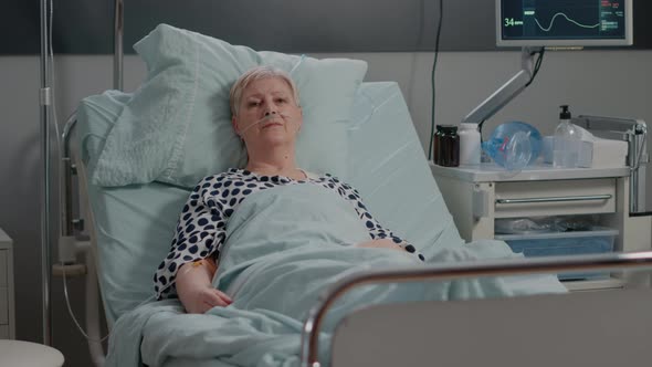 Portrait of Sick Patient Laying in Hospital Ward Bed