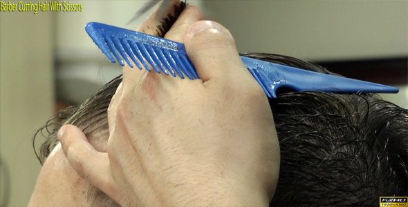 Barber Cutting Hair With Scissors