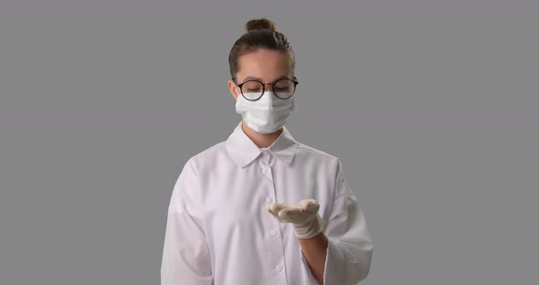 Nurse in Medical Mask Sanitize Hands with Sanitizer