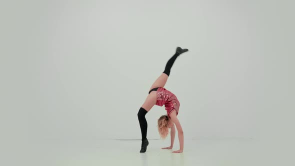 A Charming Cheerleader Demonstrates Her Stretch Does a Vertical Split and Bends in Her Back
