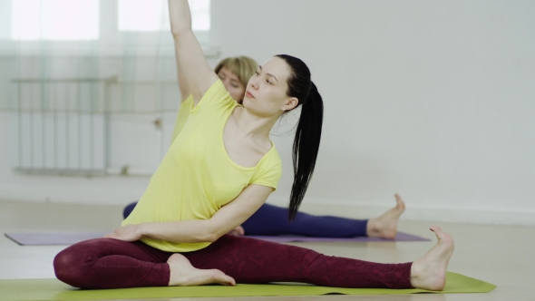 Young Woman Is Practicing The Head-to-Knee Pose