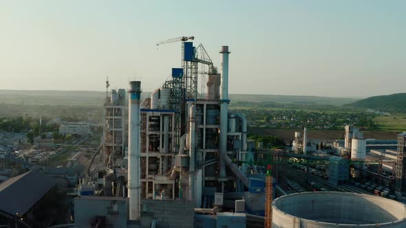 Cement Plant with High Factory Structure at Industrial Production Area at Sunset