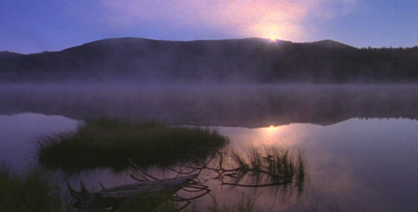 Dawn Breaks Over Misty Lake