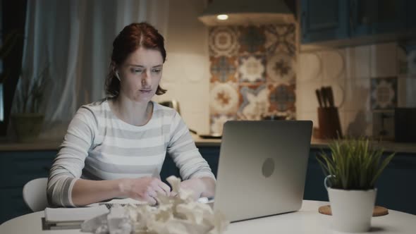 Woman In The Kitchen With Laptop, She Rips The Leaves Off Her Notebook And Throws Them Away