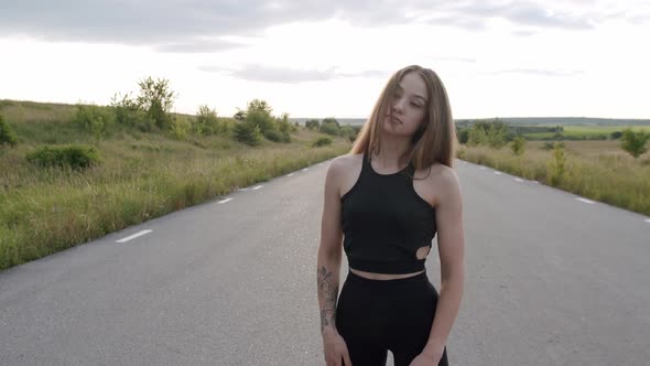 Longhaired Athletic Girl Having Workout on the Road Among Summer Nature