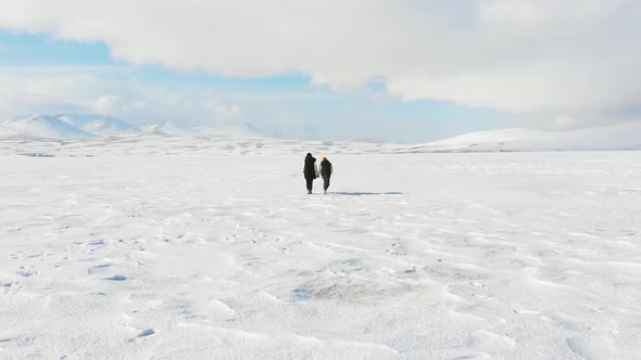 Mother With Son Walks On Frozen Lake