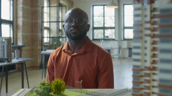 Portrait of African American Architect with House Model