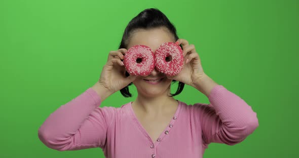 Happy Beautiful Young Girl Posing and Having Fun with Donuts. Chroma Key