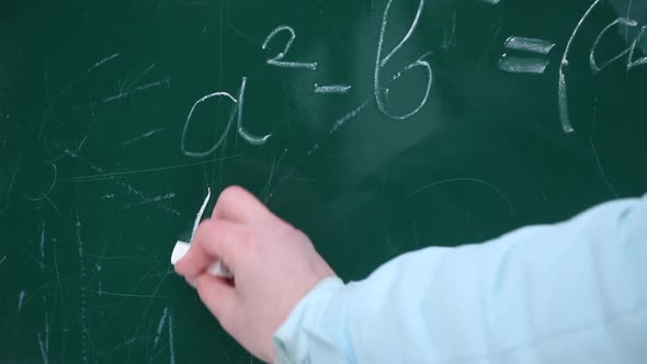 girl writing formulas on the chalkboard