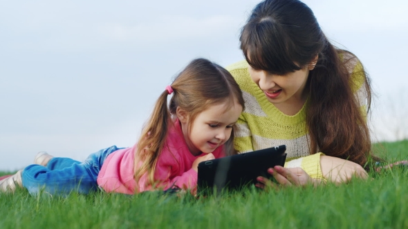 Mother And Daughter Enjoying a Picnic Tablet