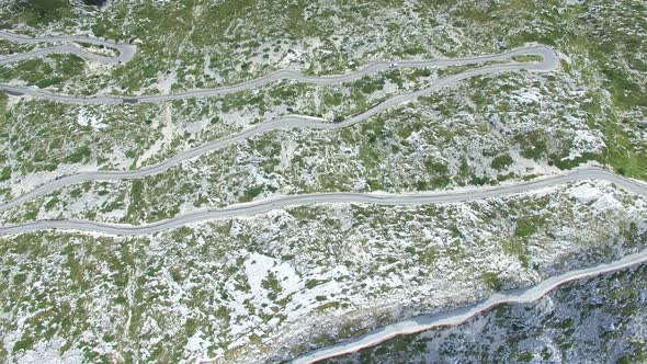 Aerial view of asphalt road curving on a hill