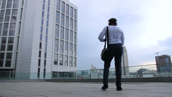 Happy Black Businessman Dancing with Joy Outdoors