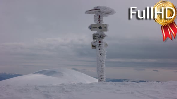 Winter Mountains Cloudscape With Direction Sign