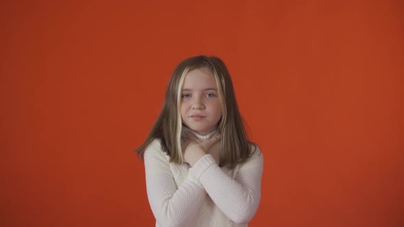 A Little Girl Has a Sore Throat Against an Orange Background