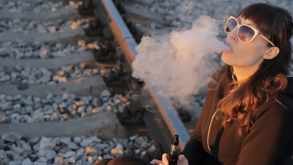 Girl Sitting On The Railway And Smokes
