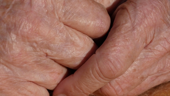 Grandmother massages painful hands