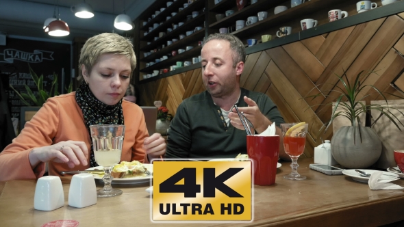 Couple Man And Woman Eats Talks In Cafe Restaurant