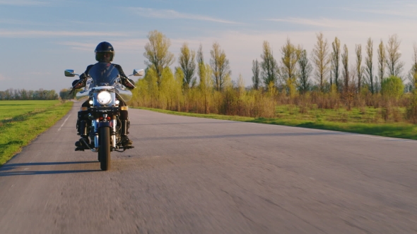 A Motorcyclist Rides Through The Countryside