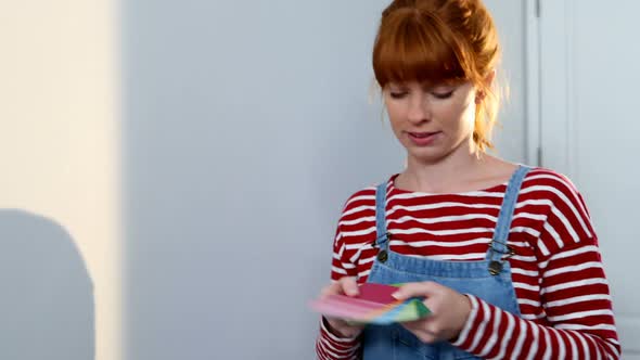 Beautiful woman looking at color swatch 