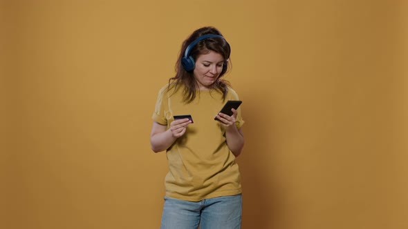 Shopaholic Woman Excited About Online Shopping Holding Smartphone Typing Credit Card Details