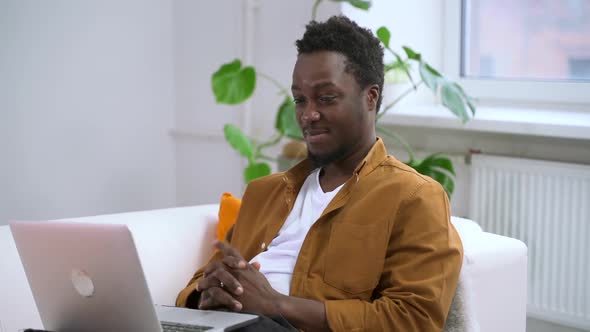 Black Man Chatting on Video Meeting in Home Interior in Room Spbas