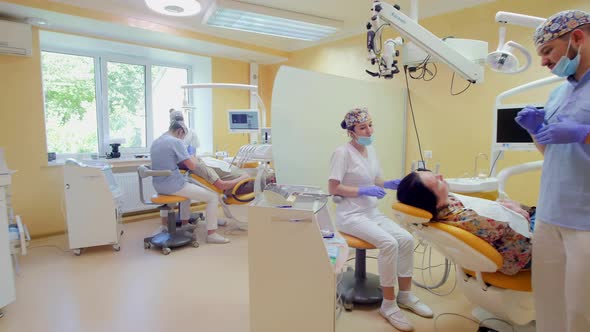 Dentists, nurses and patients in a dentistry room
