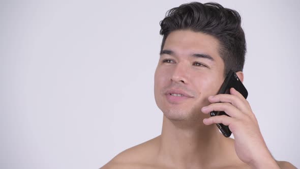 Face of Happy Young Shirtless Muscular Man Talking on the Phone