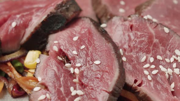 Close Up Grilled Vegetable Salad with Rare Medium Cooked Beef in a White Plate