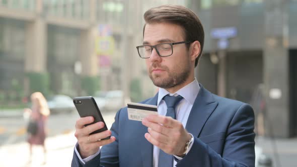 Portrait of Businessman having Online Payment Failure on Smartphone