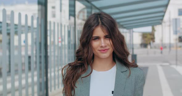 Portrait of Pretty Brunette Girl Looking To Camera and Smiling, Close Up View of Young Good Looking